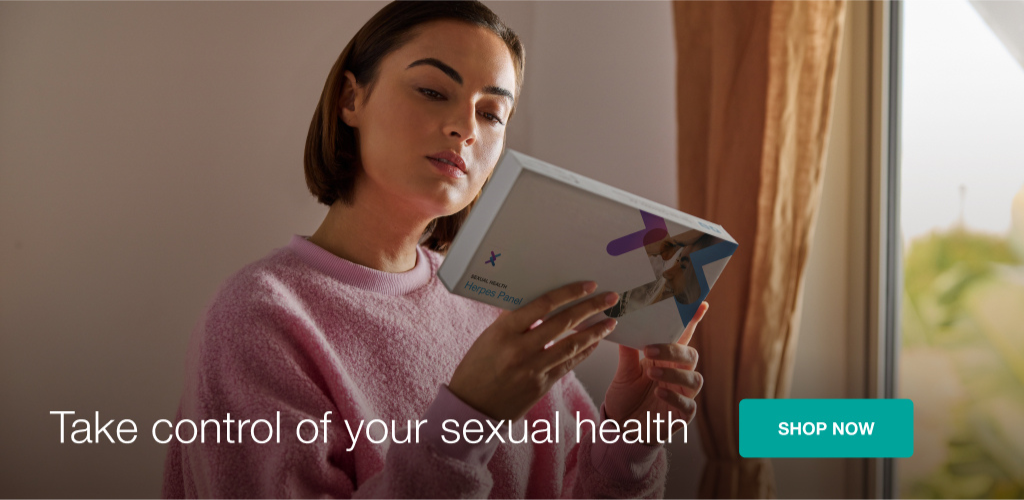 A woman holding a at-home sexual health test